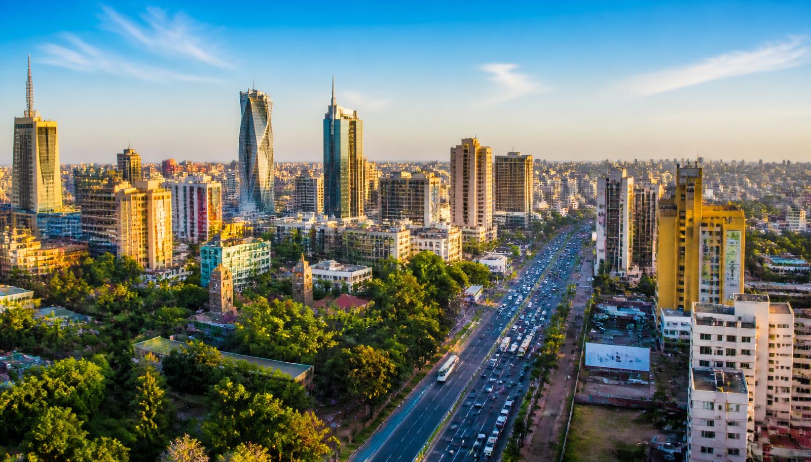 Colourful African city skyline at golden hour with busy roads, symbolising VOYA's expansion across the continent